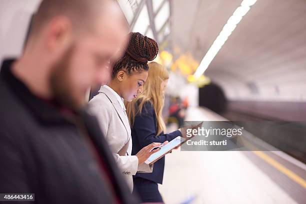 female commuter in the subway - crowded train stock pictures, royalty-free photos & images