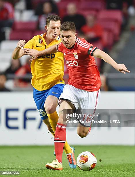Guilherme Siqueira; of Benfica is challenged by Stephan Lichtsteiner of Juventus during the UEFA Europa League Semi Final first leg match between SL...
