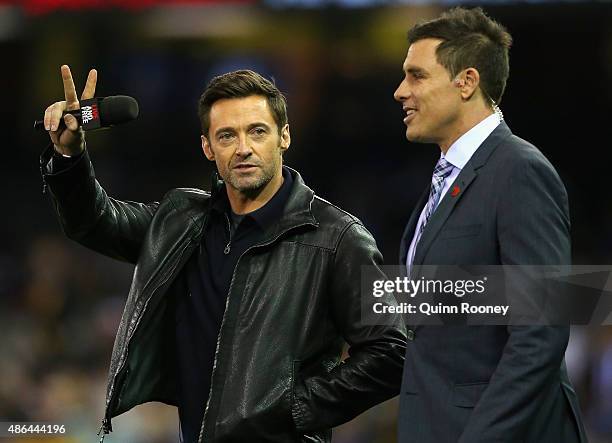 Hugh Jackman speak to Matthew Richardson during the round 23 AFL match between the Richmond Tigers and the North Melbourne Kangaroos at Etihad...