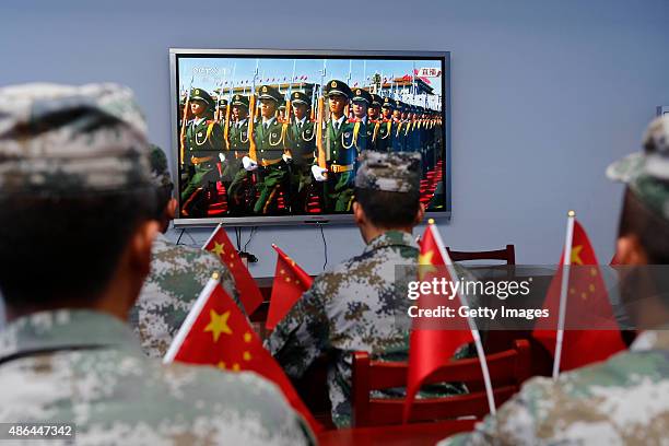 Chinese soldiers watch live broadcast of Chinese 9.3 military parade Ganyu District on September 3, 2015 in Lianyungang, Jiangsu Province of China....