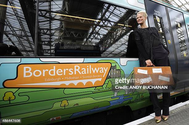 Dutch-born Scottish-based model Anna Freemantle poses alongside a Borders Railway train carriage, operated by Abellio ScotRail, during a photocall to...