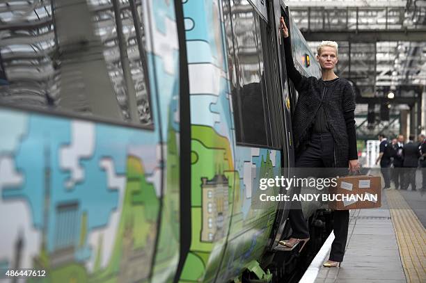 Dutch-born Scottish-based model Anna Freemantle poses alongside a Borders Railway train carriage, operated by Abellio ScotRail, during a photocall to...