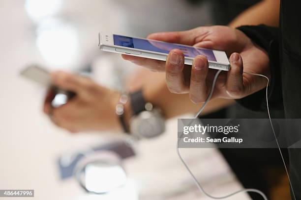 Visitor looks at an Xperia Z5 smartphone at the Sony stand at the 2015 IFA consumer electronics and appliances trade fair on September 4, 2015 in...