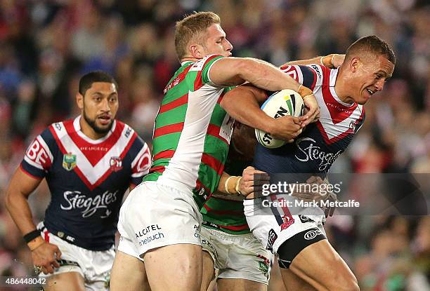 Kane Evans of the Roosters is tackled during the round 26 NRL match between the Sydney Roosters and the South Sydney Rabbitohs at Allianz Stadium on...