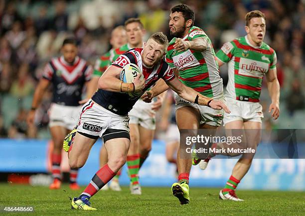 Jackson Hastings of the Roosters is tackled by Alex Johnston of the Rabbitohs during the round 26 NRL match between the Sydney Roosters and the South...