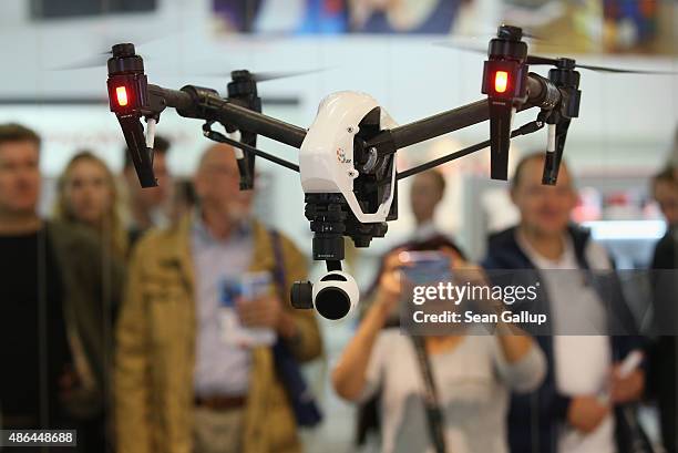 Inspire 1 quadcopter drone flies at the DJI stand at the 2015 IFA consumer electronics and appliances trade fair on September 4, 2015 in Berlin,...