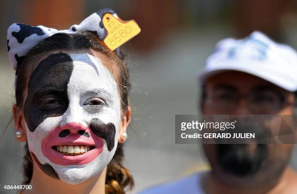 Demonstrator with make-up on her face representing a cow protests outside the Ministry of Agriculture in Madrid on the last day of an action dubbed...