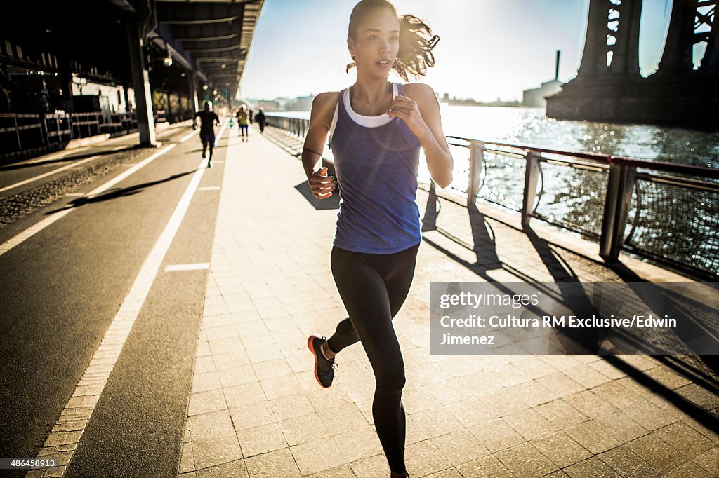 Running team, running under bridge, New York, USA