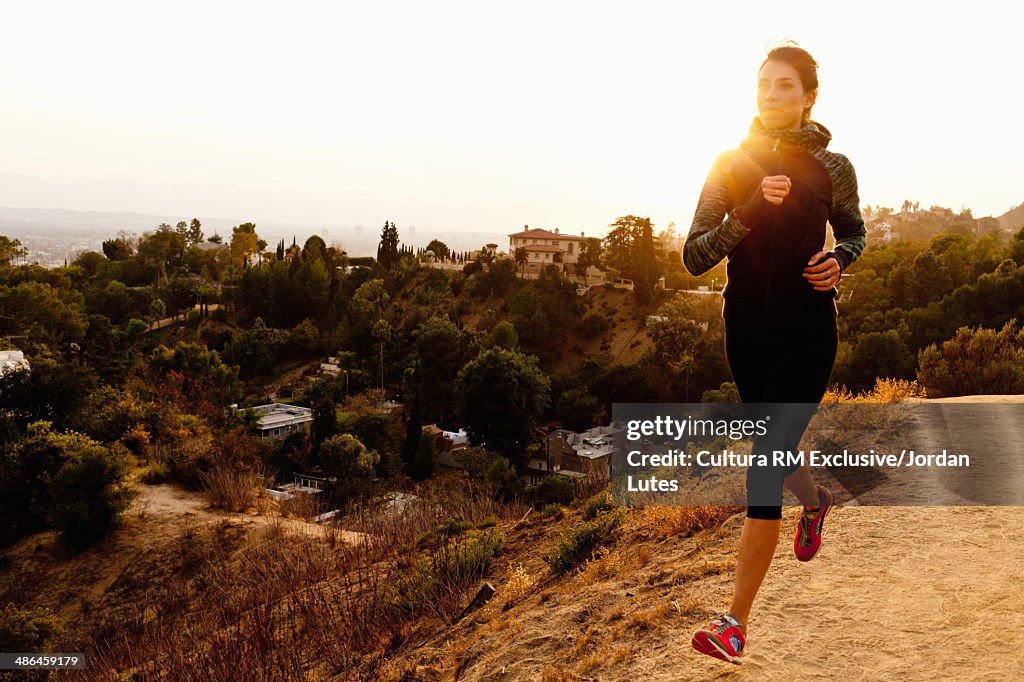 Young woman jogging on dirt track