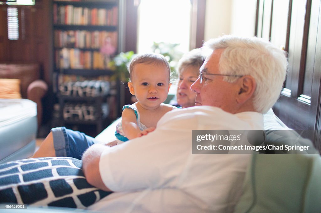 Grandparents at home with granddaughter