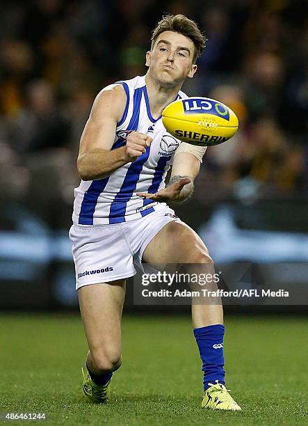 Aaron Mullett of the Kangaroos handpasses the ball during the 2015 AFL round 23 match between the Richmond Tigers and the North Melbourne Kangaroos...