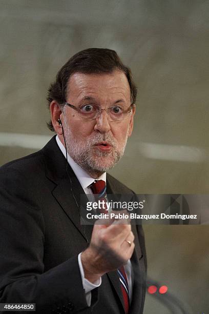 Spanish Prime Minister Mariano Rajoy speaks next to British Prime Minister David Cameron during a press conference at Moncloa Palace on September 4,...
