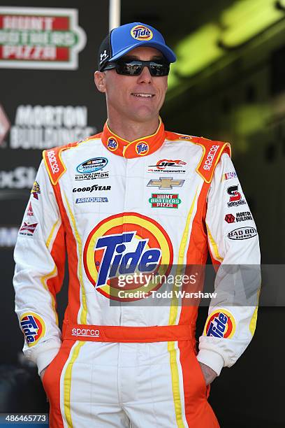 Kevin Harvick, driver of the Tide Chevrolet, stands in the garage area during practice for the NASCAR Nationwide Series 27th Annual ToyotaCare 250 at...