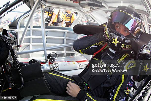 Dylan Kwasniewski, driver of the Rockstar Chevrolet, sits in his car during practice for the NASCAR Nationwide Series 27th Annual ToyotaCare 250 at...