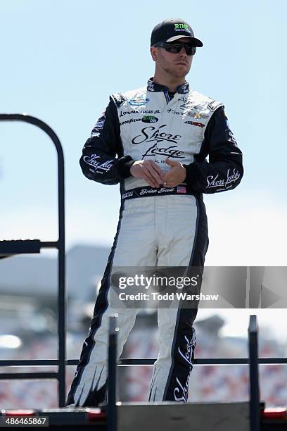 Brian Scott, driver of the Shore Lodge Chevrolet, stands in the garage area during practice for the NASCAR Nationwide Series 27th Annual ToyotaCare...