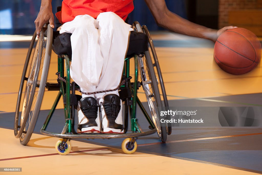 Man who had Spinal Meningitis in wheelchair dribbling basketball