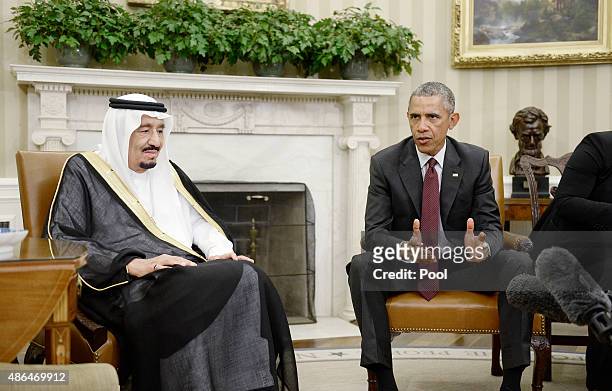 President Barack Obama speaks as King Salman bin Abd alAziz of Saudi Arabia looks on during a bilateral meeting in the Oval Office of the White House...