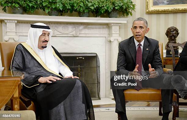 President Barack Obama speaks as King Salman bin Abd alAziz of Saudi Arabia looks on during a bilateral meeting in the Oval Office of the White House...