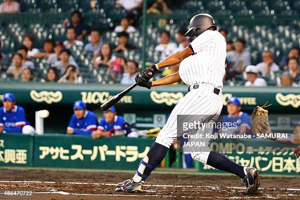 Outfielder Louis Okoye of Japan hits a single in the bottom half of the second inning the game between Australia and Japan in the super round game...