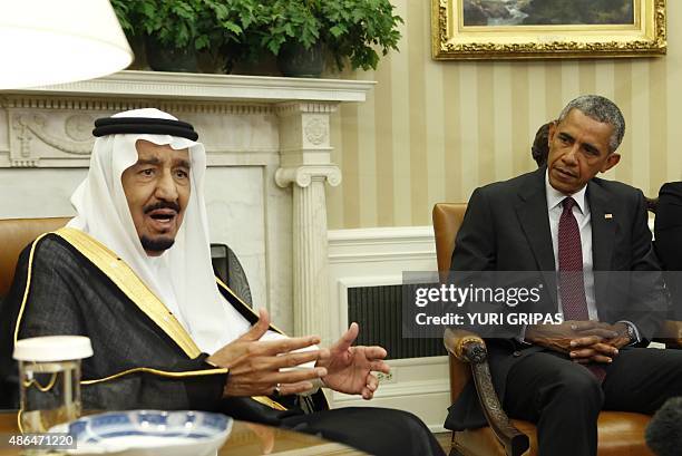 Saudi King Salman talks to the media during a meeting with US President Barack Obama in the Oval Office of the White House in Washington on September...