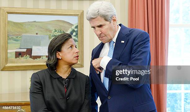 Secretary of State John Kerry speaks with National Security Adviser Susan Rice during a bilateral meeting in the Oval Office between President Barack...