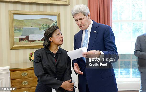 Secretary of State John Kerry speaks with National Security Adviser Susan Rice during a bilateral meeting in the Oval Office between President Barack...