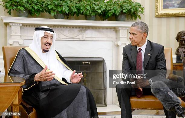 President Barack Obama looks on as King Salman bin Abd alAziz of Saudi Arabia speaks during a bilateral meeting in the Oval Office of the White House...