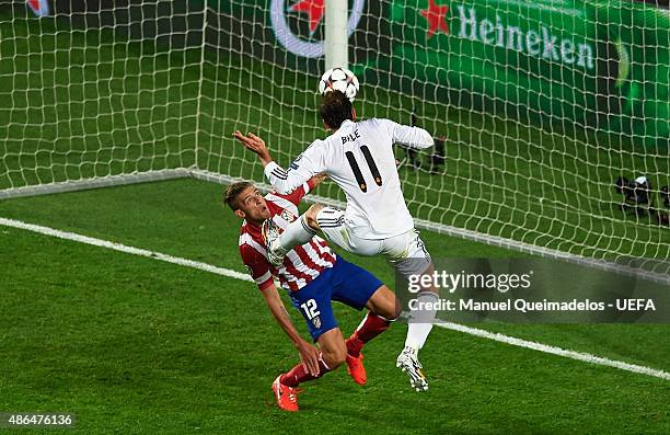 Gareth Bale of Real Madrid beats Toby Alderweireld of Atletico Madrid as he scores their second goal during the UEFA Champions League Final between...