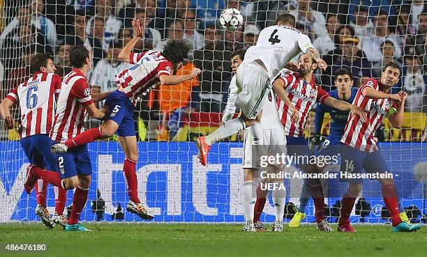 Sergio Ramos of Real Madrid scores his team's opening goal during the UEFA Champions League Final between Real Madrid CF and Club Atletico de Madrid...