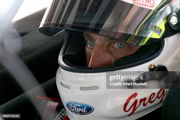 Greg Biffle, driver of the Ortho Ford, sits in his car during practice for the NASCAR Sprint Cup Series Bojangles' Southern 500 at Darlington Raceway...