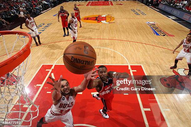 Trevor Booker of the Washington Wizards battles with Joakim Noah of the Chicago Bulls for control of the ball in Game 2 of the Eastern Conference...