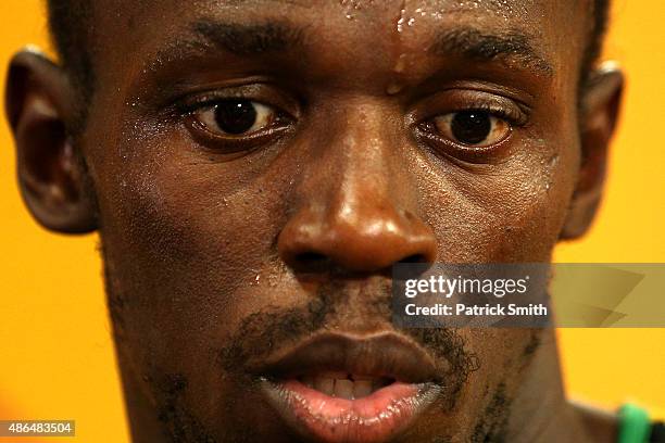 Usain Bolt of Jamaica speaks to the media after crossing the finish line to win gold in the Men's 200 metres final during day six of the 15th IAAF...