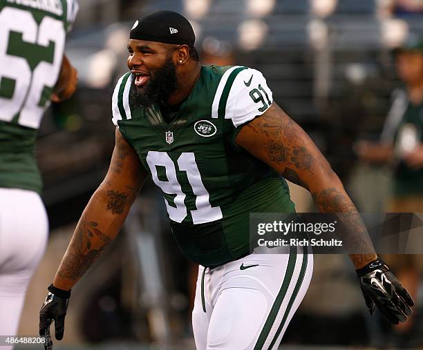 Sheldon Richardson of the New York Jets laughs on the field before a pre-season game against the Philadelphia Eagles at MetLife Stadium on September...