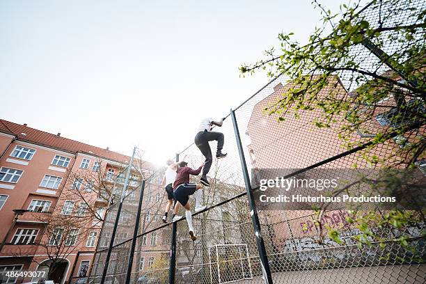 entering urban soccer place - wire mesh fence stock-fotos und bilder