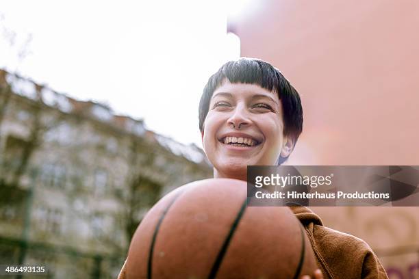 young woman with basketball - basketball sport stock-fotos und bilder