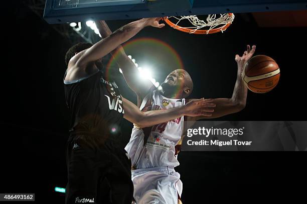 Patricio Garino of Argentina dunks the ball against Miguel Ruiz of Venezuela during a match between Venezuela and Argentina as part of the 2015 FIBA...