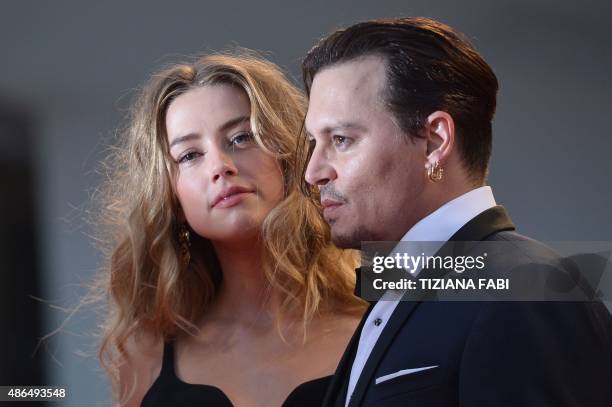 Actor Johnny Depp and his wife US actress Amber Heard arrive for screening of the movie "Black Mass" presented out of competition at the 72nd Venice...