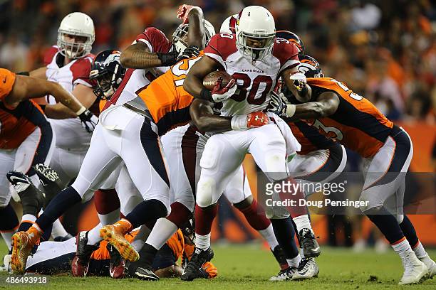 Running back Stepfan Taylor of the Arizona Cardinals carries the ball against the Denver Broncos during preseason action at Sports Authority Field at...