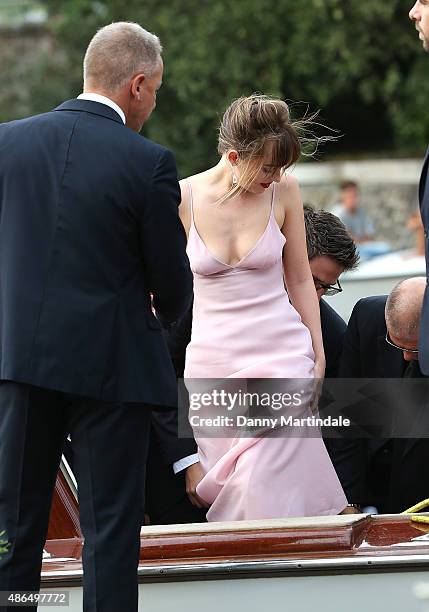 Dakota Johnson gets her dress stuck on the boat as she arrives for the 'Black Mass' Premiere on day 3 of the 72nd Venice Film Festival on September...