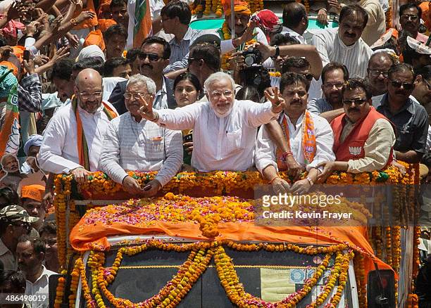 Leader Narendra Modi gestures to the crowd on his way to filing his nomination papers on April 24, 2014 in Varanasi, India. India is in the midts of...