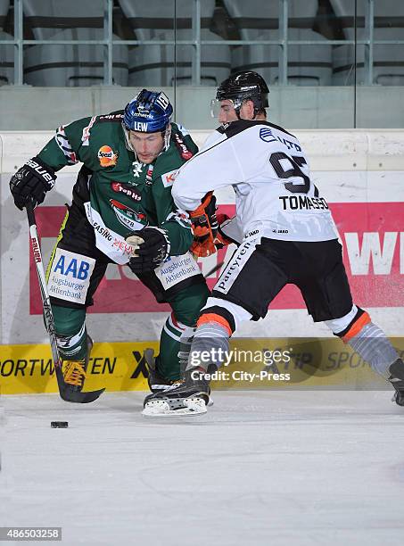 Ivan Ciernik of the Augsburger Panther handles the puck against Matt Tomassoni of Loewen Frankfurt during the game between Augsburger Panther against...