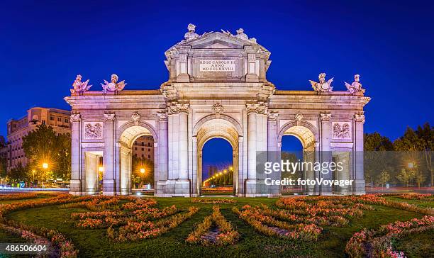madrid puerta de alcala iconic monumental gate illuminated dusk spain - madrid stock pictures, royalty-free photos & images
