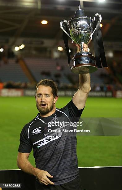 The captain of the Rest of the World, Shane Williams lifts the trophy after victory in the Rugby Aid 2015 celebrity rugby match between England and...