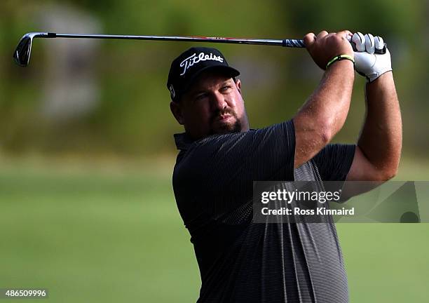 Brendon de Jonge of Zimbabwe watches his second shot on the seventh hole during round one of the Deutsche Bank Championship at TPC Boston on...