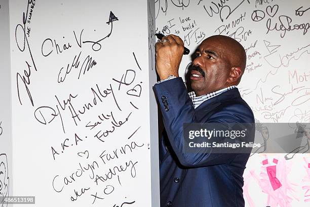 Steve Harvey signs the AOL wall at AOL BUILD Speaker Series: Steve Harvey at AOL Studios In New York on September 4, 2015 in New York City.