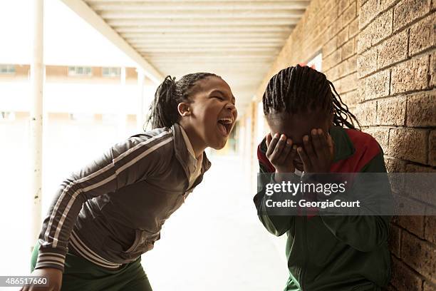 school girl bullies another girl - bullying stockfoto's en -beelden