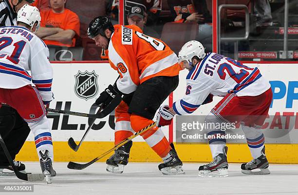 Nicklas Grossmann of the Philadelphia Flyers battles for the puck against Martin St. Louis of the New York Rangers in Game Three of the First Round...