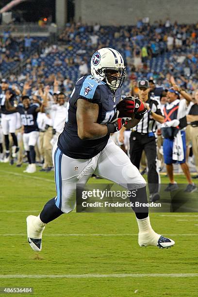 Angelo Blackson of the Tennessee Titans scores a touchdown after making a reception on a botched extra point attempt during a pre-season game against...