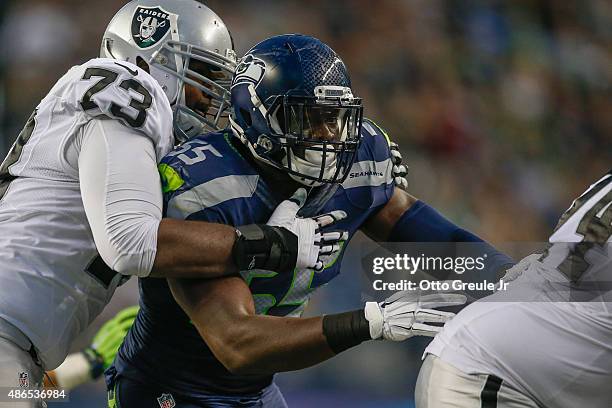 Defensive end Frank Clark of the Seattle Seahawks in action against Matt McCants of the Oakland Raiders at CenturyLink Field on September 3, 2015 in...