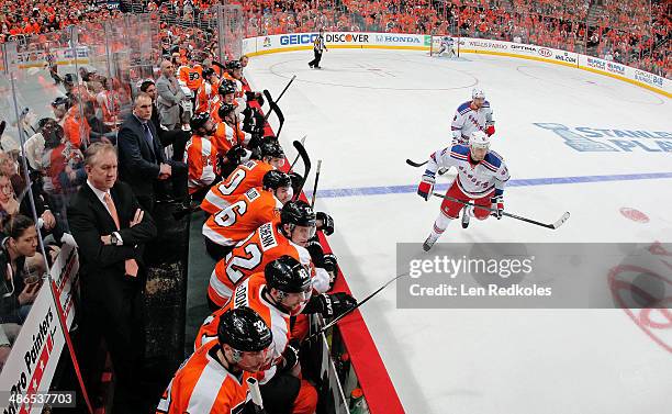 Rick Nash and Kevin Klein of the New York Rangers skate in front of the bench of the Philadelphia Flyers in Game Three of the First Round of the 2014...